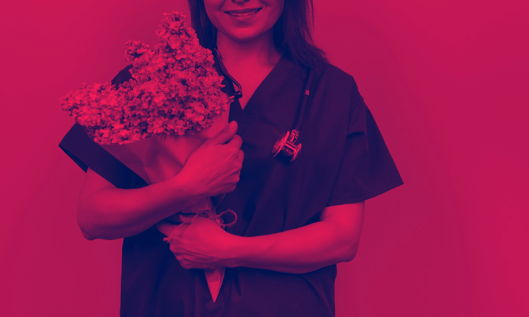 A Magnet Medical traveler smiling with a bouquet of flowers they received during Nurses Week in 2023.